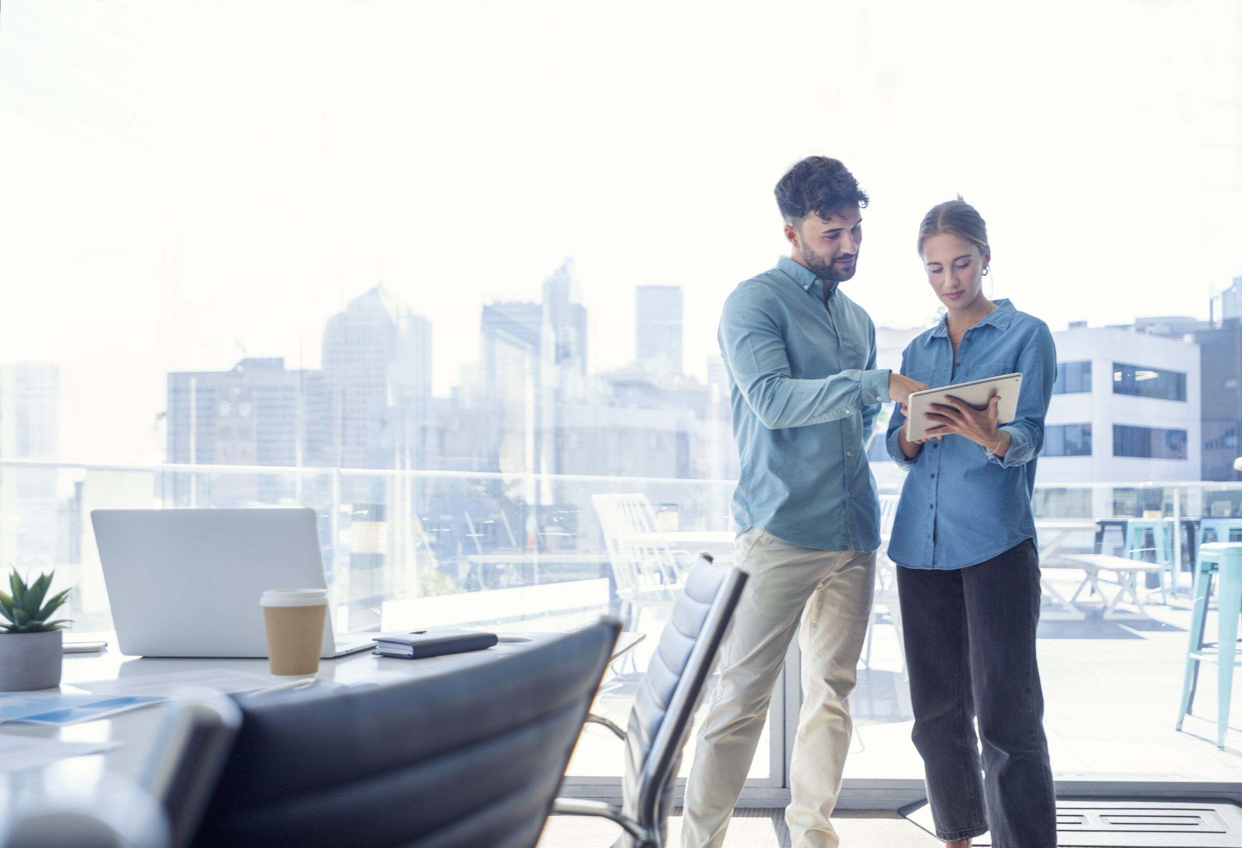 Businessman and businesswoman looking at a digital tablet.