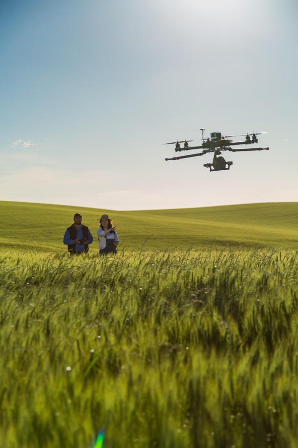 Field technicians using drone technology for large-scale infrastructure inspection