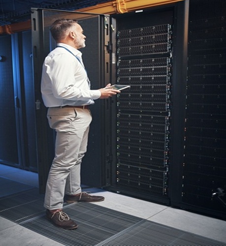 Technician inspecting server infrastructure for private 5G asset connectivity