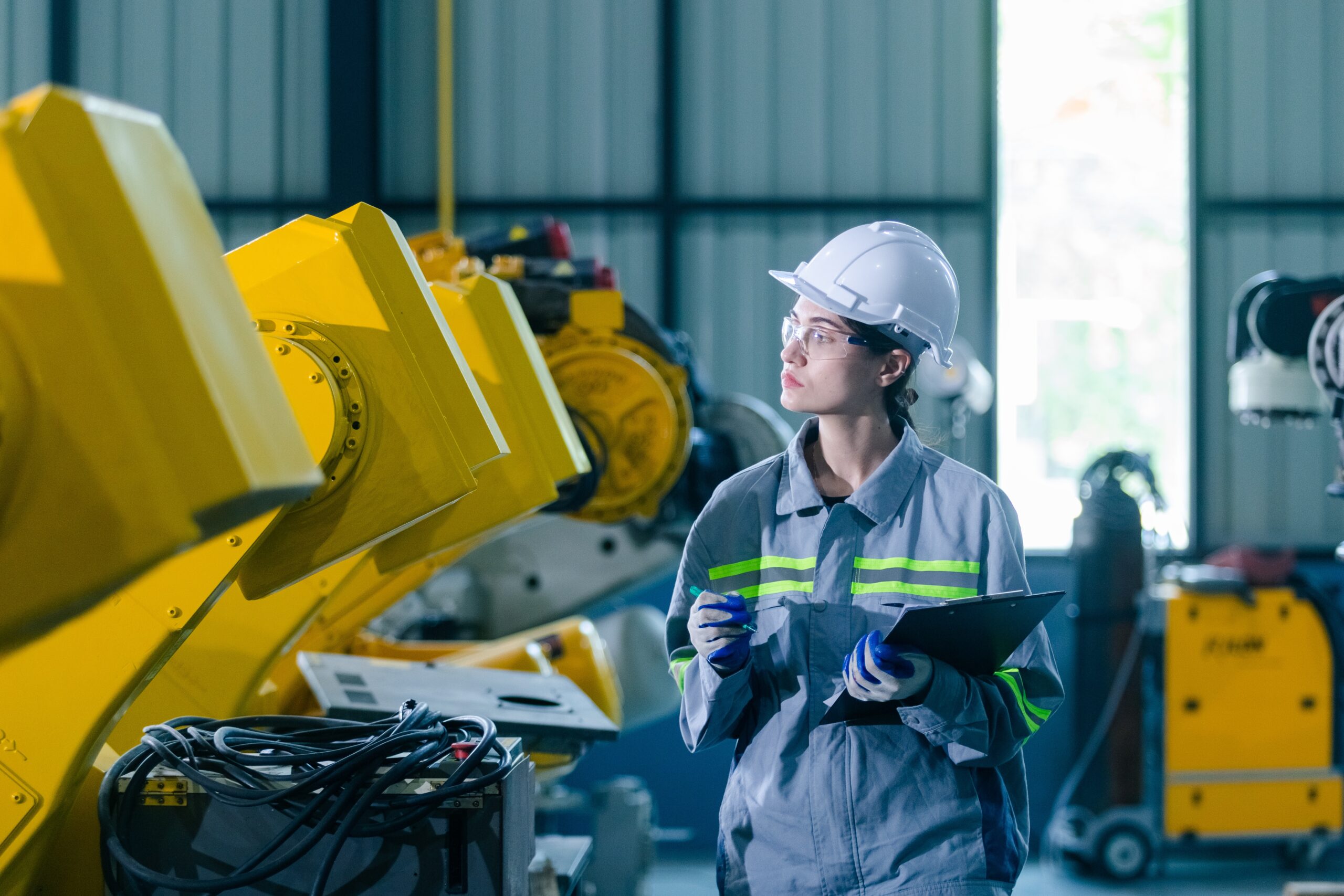 Industrial engineer inspecting robotic equipment to improve tool control and reduce missing tools during shift changes
